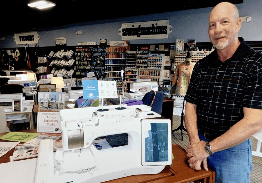man in sewing machine store